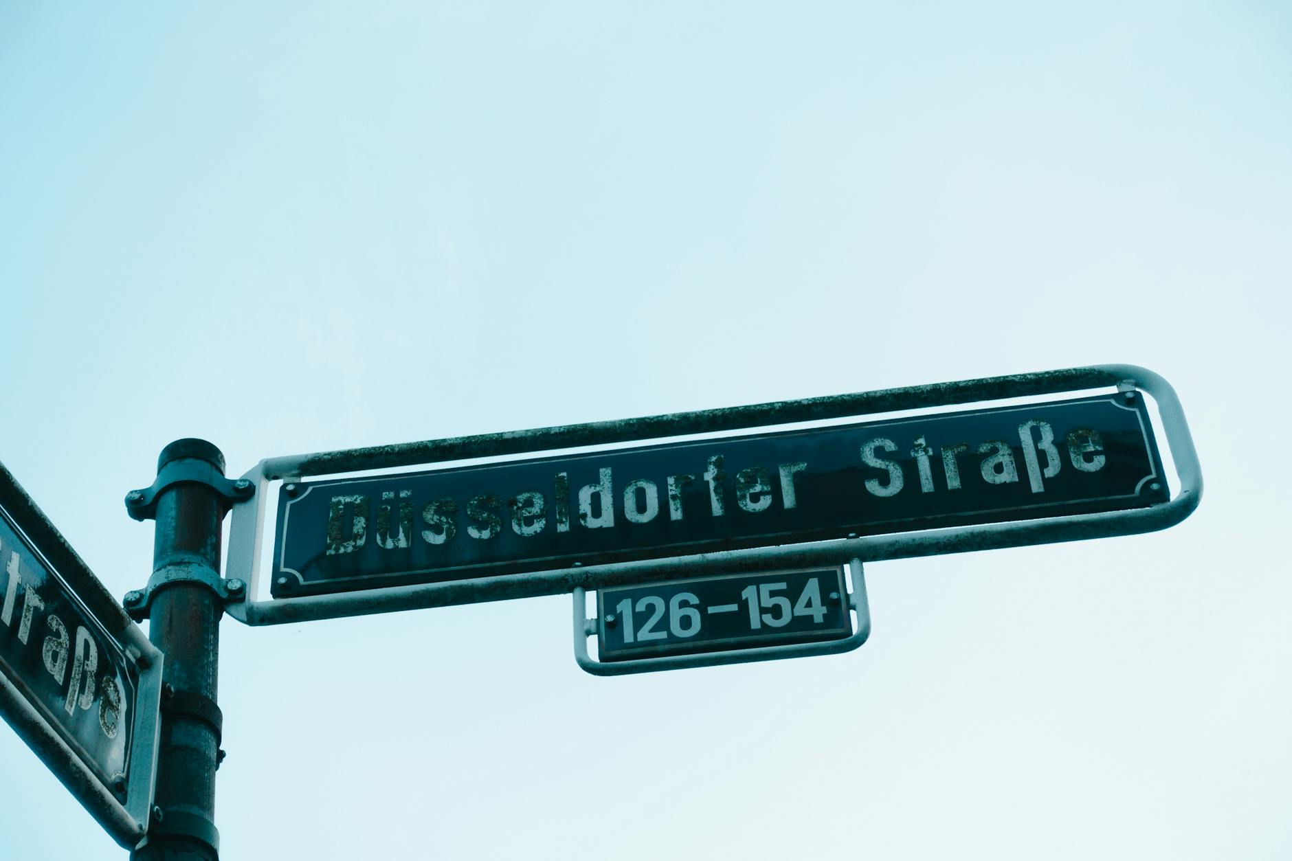 Pedestrian street in central Stockholm with directional signs a walking map covers