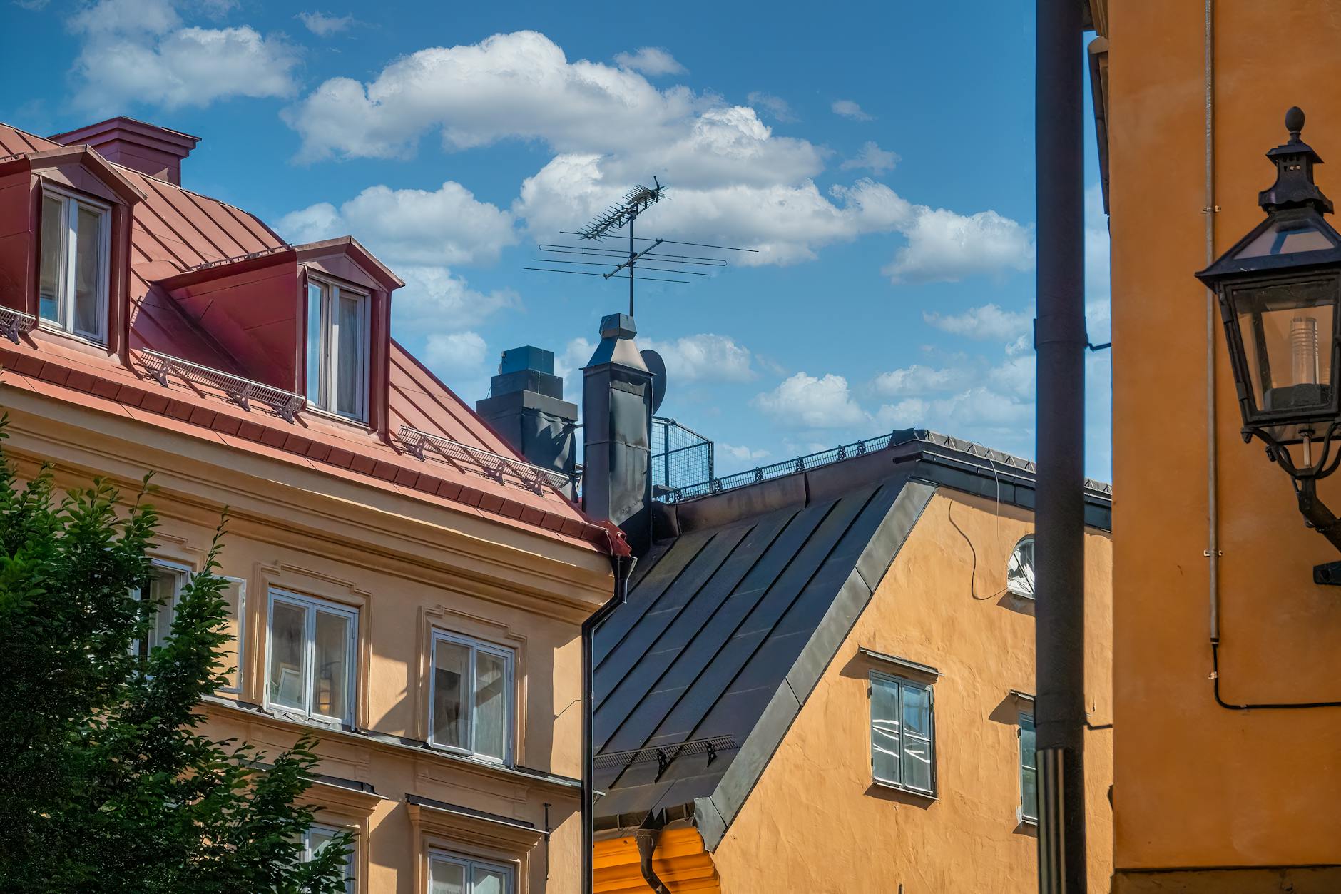 Elevated panoramic view across Stockholm rooftops and the waterfront under a clear sky